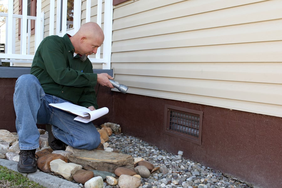 Home inspector checking the foundation.